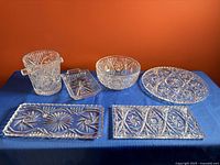 all six crystal/glass items displayed on table