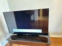 Front view of Philips TV powered on displaying 'No Signal' message