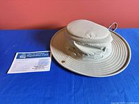 Hat and registration card displayed on table