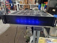 Front of controller/amplifier with six blue LEDs lit