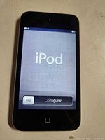 Front view of powered-on Apple iPod Touch showing setup screen