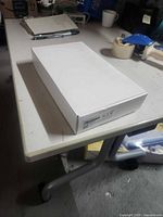 Closed white box with barcode label on end