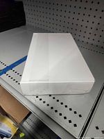 Sealed white ADT touchscreen box top view