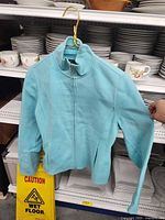 Front view of aqua zip sweater