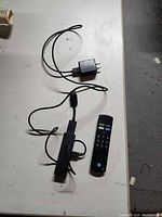 Fire TV Stick, USB power cable, wall adapter and remote on tabletop
