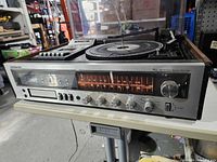 Front view showing tuner scale, cassette deck, knobs and controls