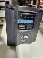 Front view showing APC logo, model name, and LCD display