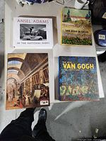 Four art books laid out on table