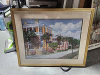 Framed palm-lined street scene print with mat and gold frame