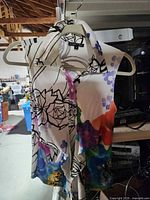 Front view of sleeveless floral blouse on hanger