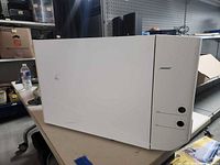 Front/side view of white Bose subwoofer module