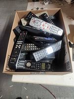 Top view of box showing assorted remotes piled together