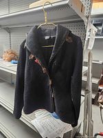 Front view of Covelo black jacket with floral appliqués