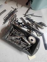 Top view of small bin and loose drill bits, showing variety and condition