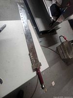 Full view of decorative sword on table