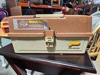 Front view of closed Plano beige/brown tackle box model 6103