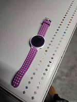 Front view of Garmin Forerunner 220 with purple strap