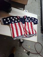 Front of Gina Peters US flag cardigan showing button front, red/white stripes and navy star field