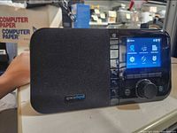 Front view showing Grace Digital unit with speaker, screen, control knob, preset buttons.