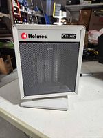 Front view of Holmes ceramic space heater showing mesh grill and branding