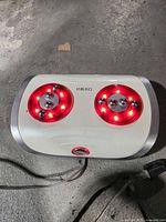 Top view showing full unit with red illuminated massage heads