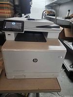Front and top view of HP Color LaserJet Pro printer on table