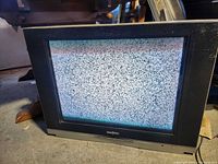 Front view of Insignia CRT TV displaying static