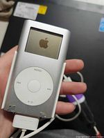 Front view of silver Apple iPod mini showing screen and click wheel