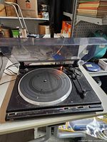 Overall view of JVC turntable with dust cover open