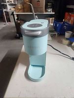 Front view of mint Keurig K-Mini showing slim profile and branding