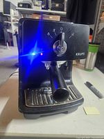 Front view of Krups espresso machine powered on