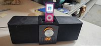 Logitech speaker dock with pink iPod inserted, full view