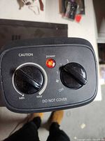 Top control panel showing thermostat and mode knobs with power indicator