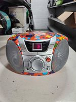 Front view showing LED display, controls and speakers