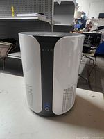 Front view of cylindrical Miko air purifier showing power button and intake vents
