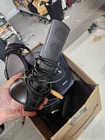 Dell subwoofer and two wired satellite speakers with cords in cardboard box