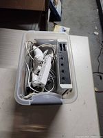 Console and cables stored in plastic bin