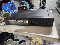 Front view showing Onkyo T-4015 tuner, display, buttons and indicators