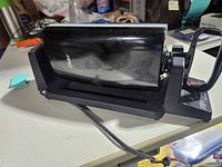 Left side view of Oster 7 Minute Grill showing housing and base