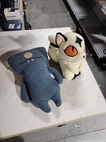 Kirara and Uglydoll plush side by side on table