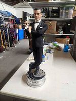Front view of 21 in James Bond statue on 007 base