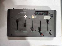 Top view of RadioShack stereo mixer showing faders and VU meter