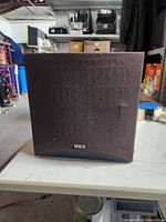 Front view of RCA subwoofer with grille and logo