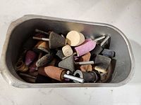 Metal tray filled with assorted rotary grinding and polishing bits