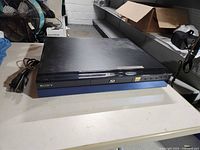 Top and front of Sony Blu-ray player with power cord visible