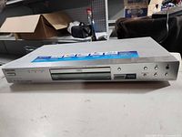 Front view of silver Sony DVD player showing disc tray and front controls