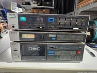 Front view of the three stacked Sony components showing controls and displays