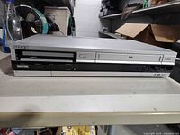 Front view of Sony SLV-D360P combo showing DVD tray without faceplate and VHS slot