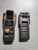 Front view of both stopwatch printers showing displays, buttons and paper slots