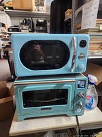 Stacked teal KitchenAid toaster oven below Galanz microwave